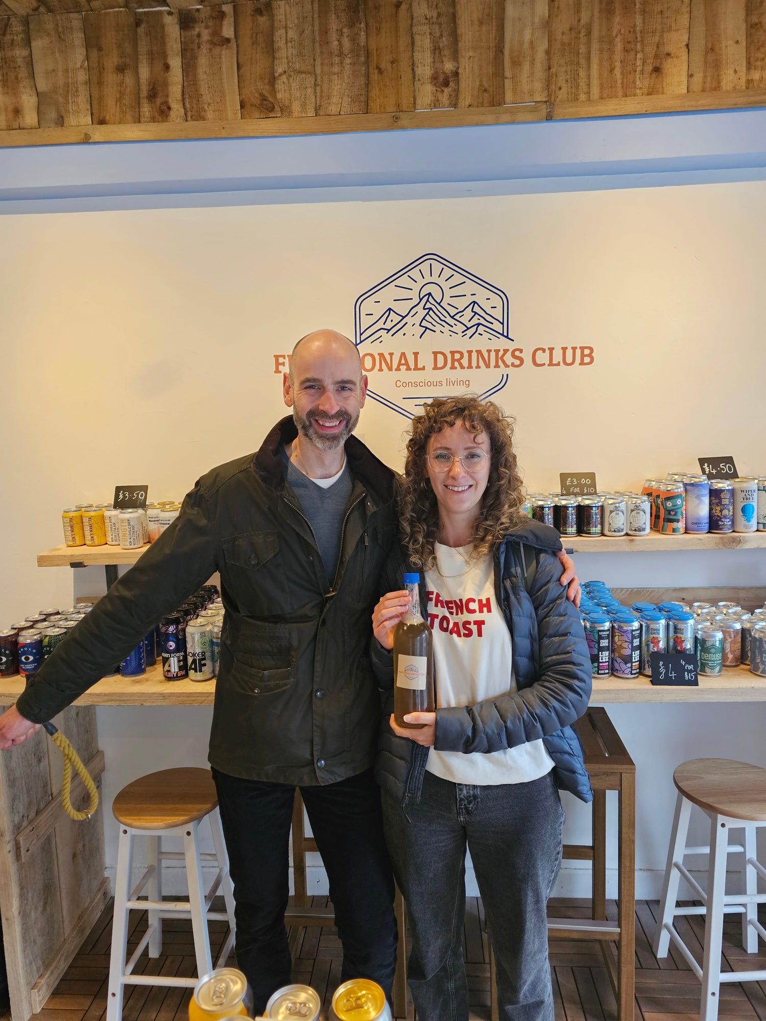 A couple holding a Functional Drinks Club Kombucha Refill Bottle