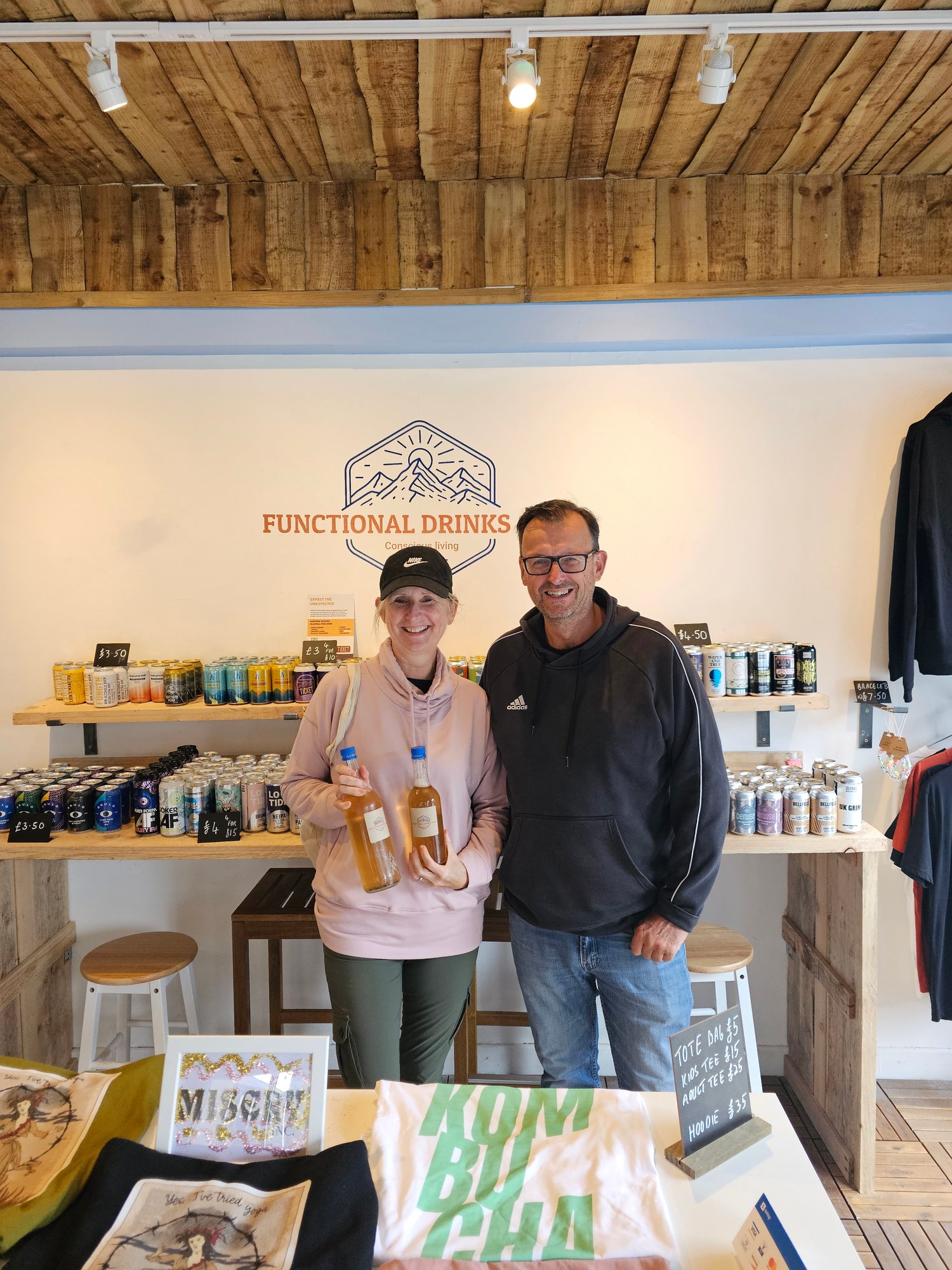 Older couple holding a Functional Drinks Club Kombucha refill bottle