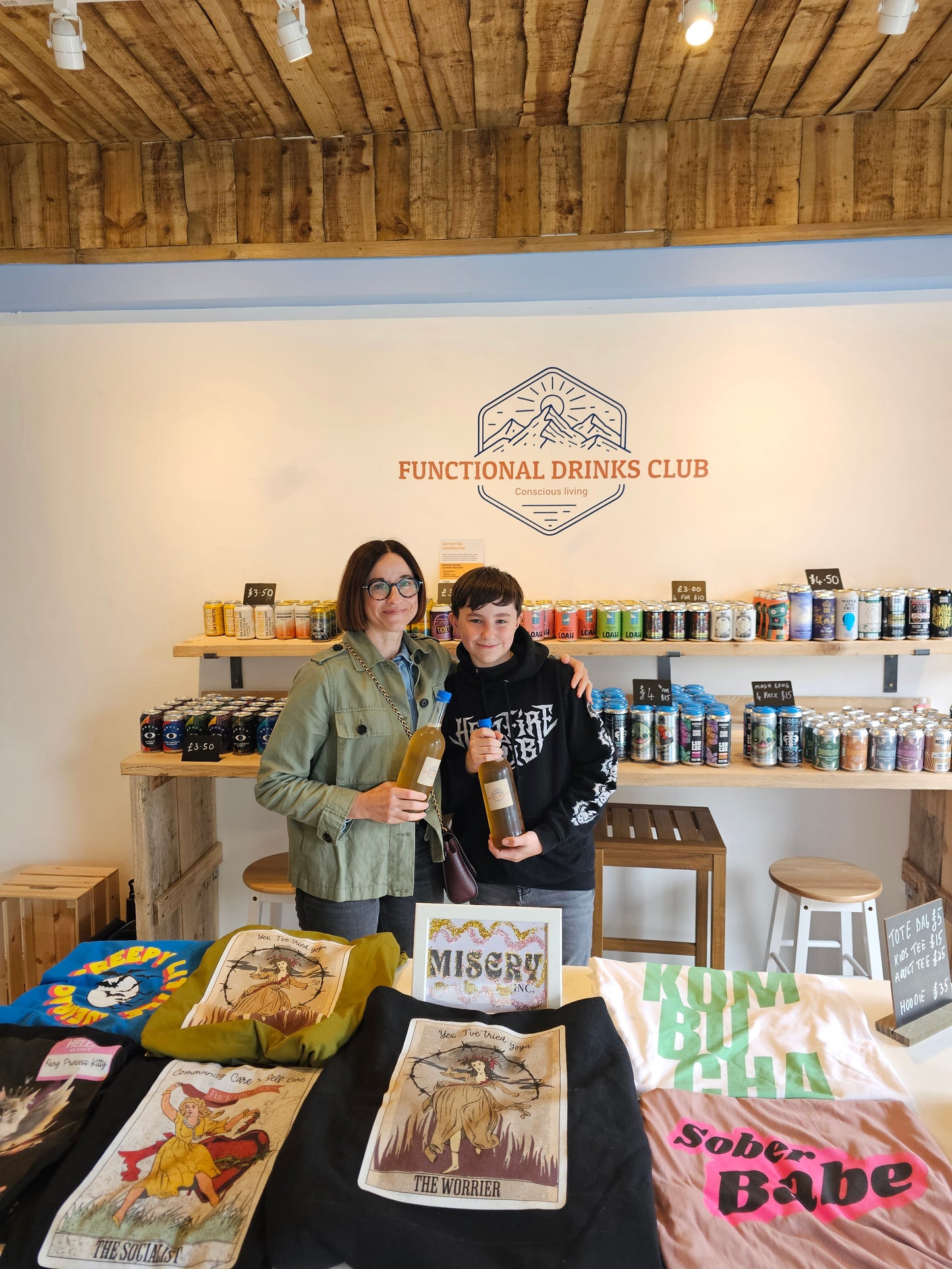 Picture of Functional Drinks Club customer holding their refill Kombucha bottle