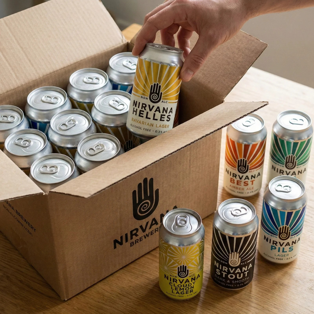 Box of Nirvana Brewery beer cans with a hand reaching for a can on a wooden surface.