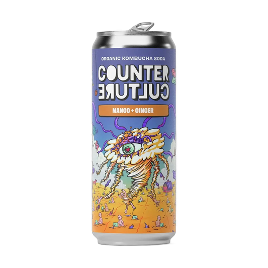 Counter Culture Mango & Ginger raw kombucha in a 330ml can with a silver cap and a purple and orange illustrated label.