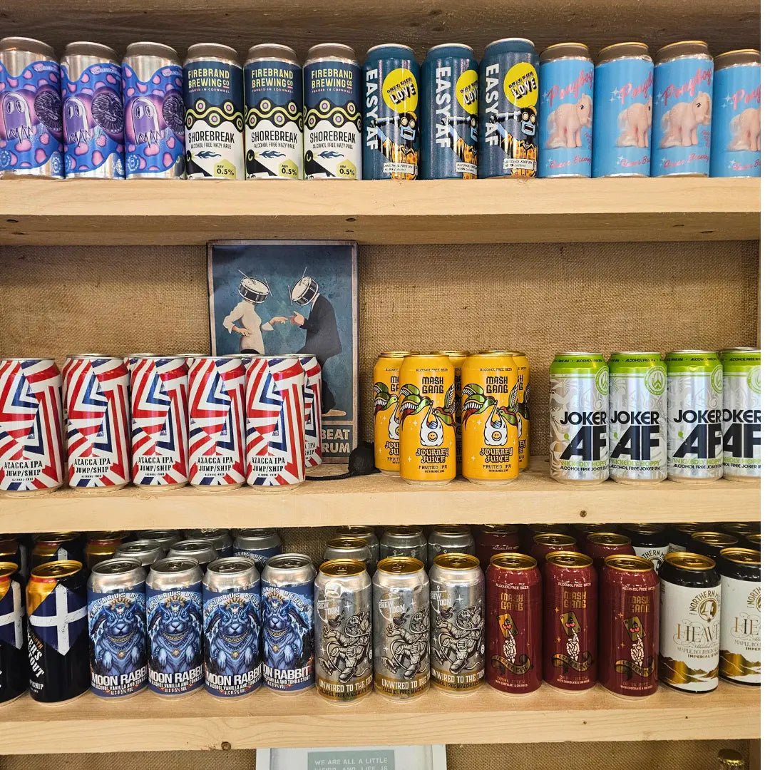 Three wooden shelves stocked with various colorful canned beverages from brands like Joker's, Easy Star, and Sours.