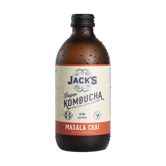 Jack's Masala Chai raw kombucha in an amber 330ml glass bottle with a black cap and a cream label with a burnt orange flavour band.
