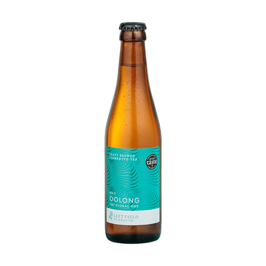Left Field No.3 Oolong raw kombucha in a tall amber 330ml glass bottle with a black cap and a turquoise swirl-patterned label.