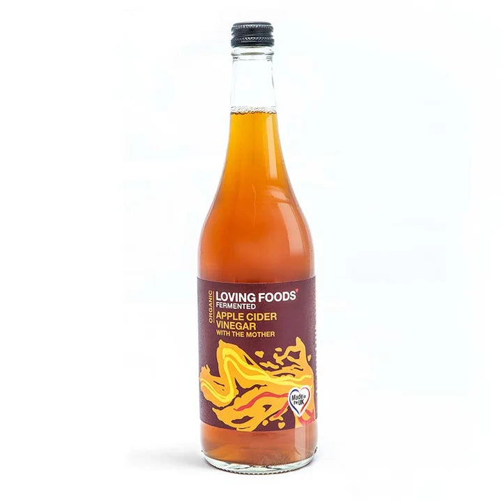 A glass bottle of Loving Foods organic fermented apple cider vinegar with the mother