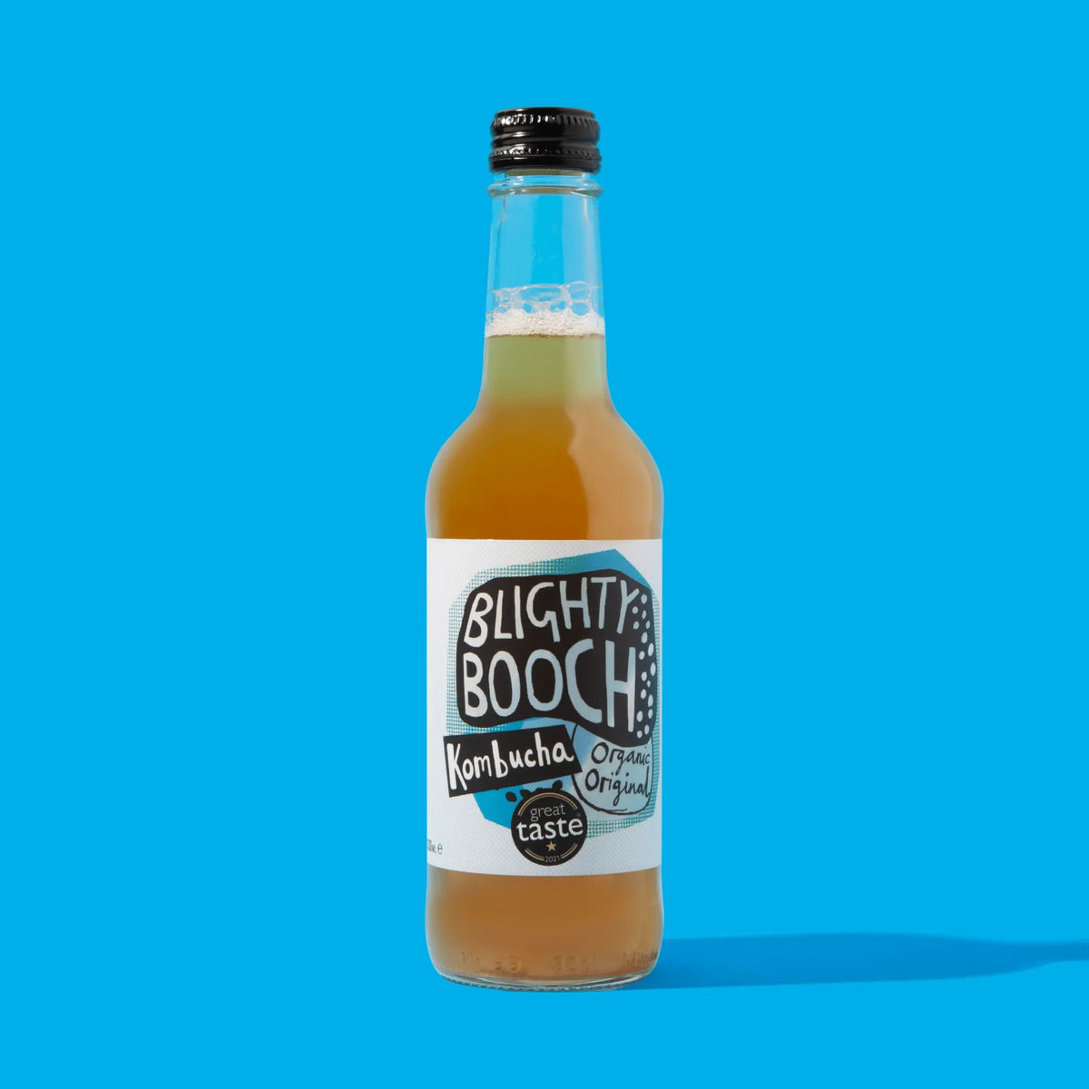 Bottle of Blighty Booch Kombucha on a blue background