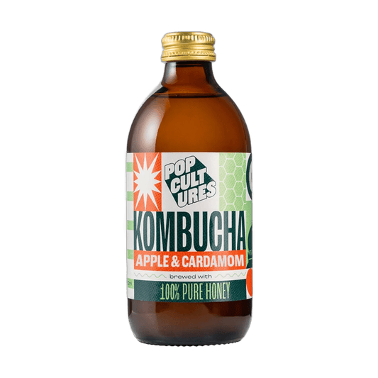 Pop Cultures Apple & Cardamom raw jun kombucha in an amber 330ml glass bottle with a gold cap and a colourful orange and green patchwork label.