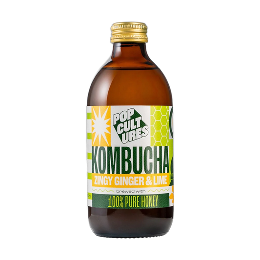 Pop Cultures Zingy Ginger & Lime raw jun kombucha in an amber 330ml glass bottle with a gold cap and a colourful lime green and yellow patchwork label.