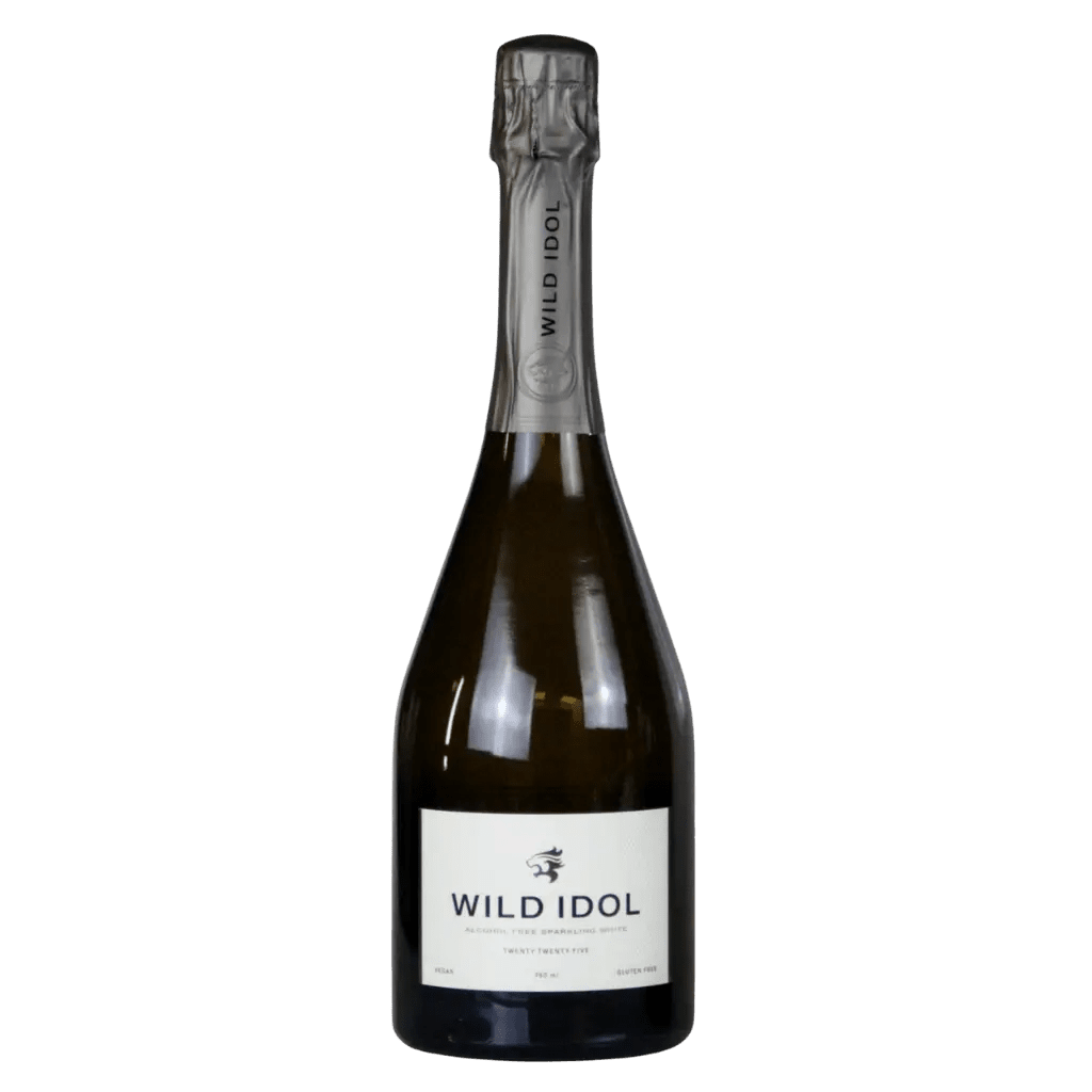 A bottle of Wild Idol sparkling wine with a white label and dark glass, sealed with a metallic silver foil capsule, set against a plain white background.